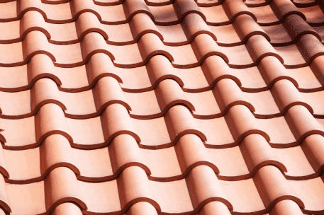 Red clay roof tiles arranged in overlapping rows creating geometric pattern