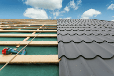 Roof construction showing wooden frame structure and gray metal tiles installation