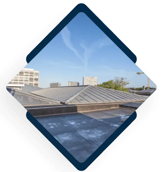 Modern metal roofing installation on commercial building with city skyline view