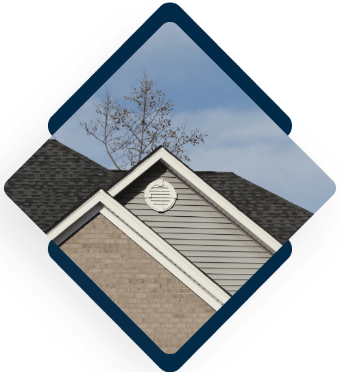Modern residential home exterior with gray siding and dark shingle roof