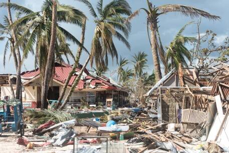 Hurricane destruction of coastal homes and palm trees