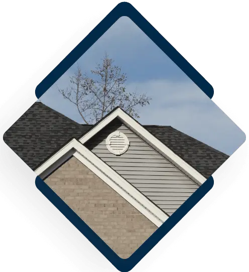 Modern residential home exterior with gray siding and dark shingle roof