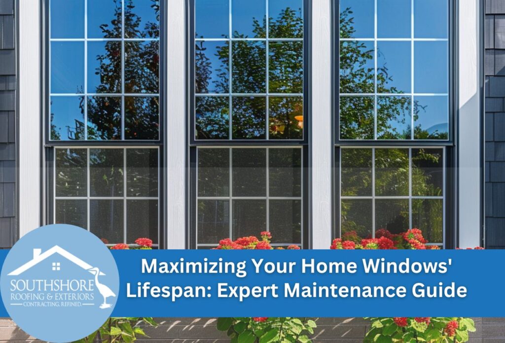 White framed windows with red flower boxes on gray shingled house exterior