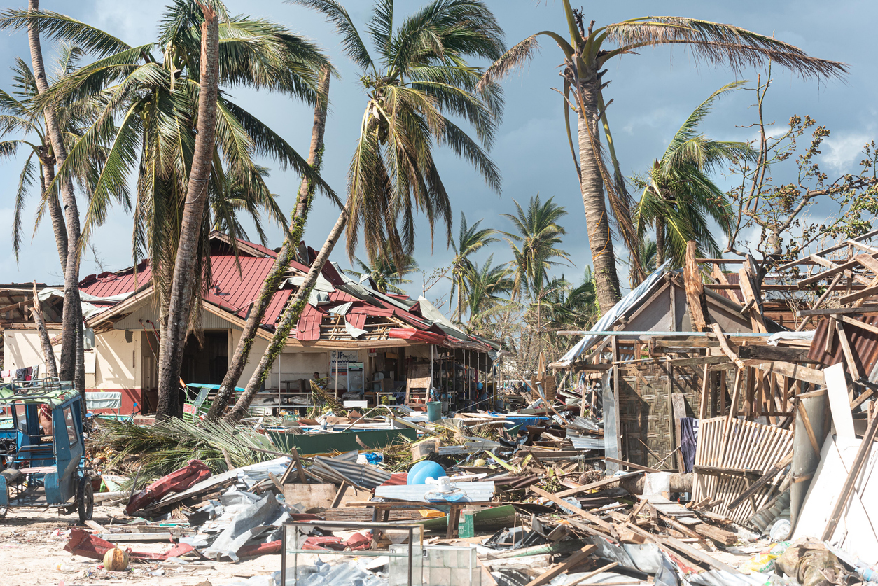 Hurricane destruction of coastal homes and palm trees